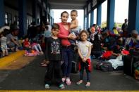 The Wider Image: Venezuelan mothers, children in tow, rush to migrate