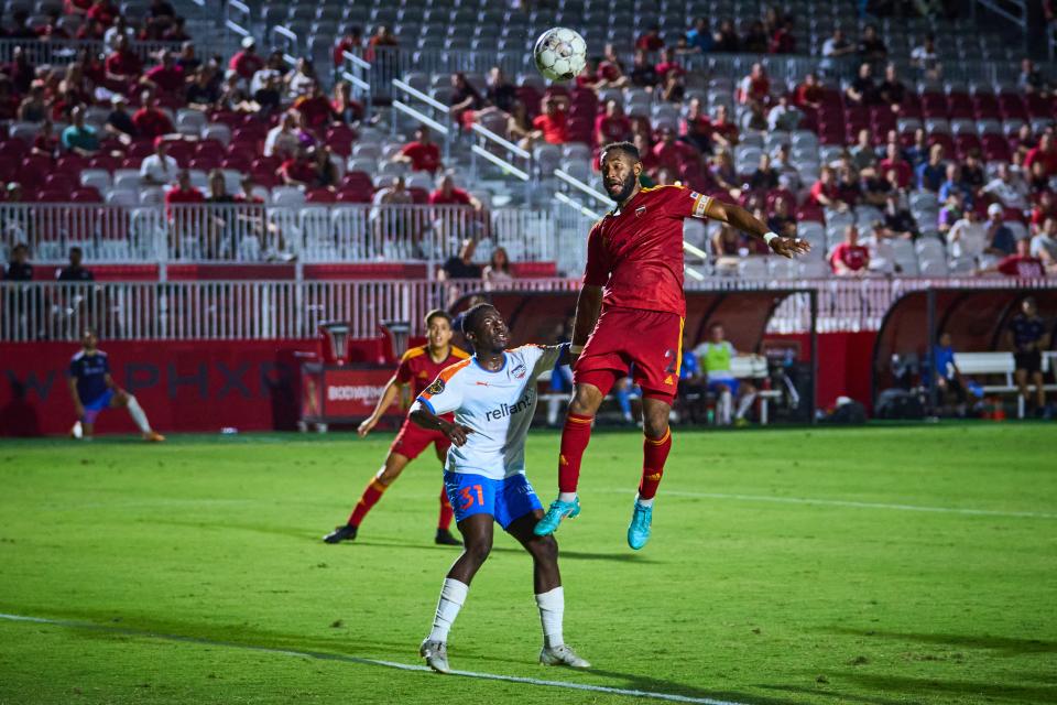 Aug 31, 2022; Chandler, Arizona, USA; The ball bounces off the head of Phoenix Rising defender Darnell King (2) as RGV Toros defender Akeem Ward (31) watches at Phoenix Rising FC Stadium.