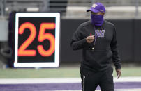 Washington head coach Jimmy Lake stands near a play clock during NCAA college football practice, Friday, Oct. 16, 2020, in Seattle. (AP Photo/Ted S. Warren)