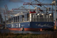 SOUTHAMPTON, ENGLAND - DECEMBER 10: A man walks near the Marco Polo, the world's biggest container ship, at Southampton docks on December 10, 2012 in England. On its first visit to Europe, the 54m (177ft) wide and 396m (1299ft) long container ship - which is 51m (167ft) longer than the Queen Mary II - will mostly carry consumer goods for delivery to shops for Christmas. (Photo by Peter Macdiarmid/Getty Images)