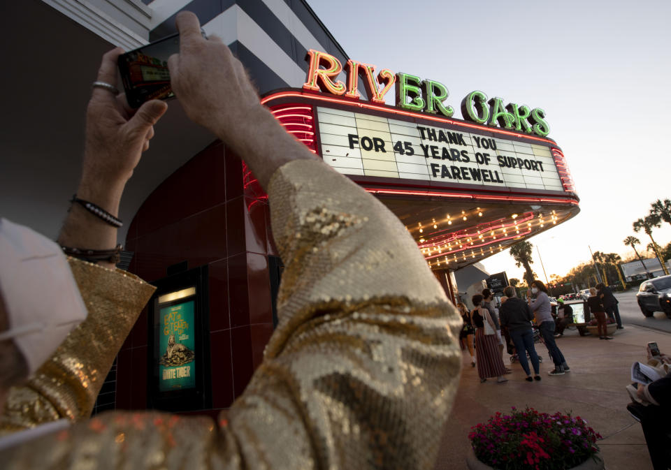 David Purdie takes a photograph of the River Oaks Theatre farewell marquee sign on the final day of showing films Thursday, March 25, 2021, in Houston. Purdie, who grew up in the neighborhood, said he has been coming to the theater and watching films since 1971. (Yi-Chin Lee/Houston Chronicle via AP)