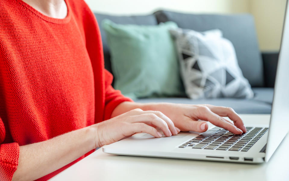 A woman using a laptop.