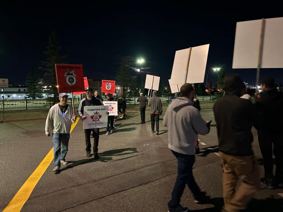 Members of the Teamsters Canada Rail Conference rally at the Canadian Pacific Ogden Yard in Calgary. 