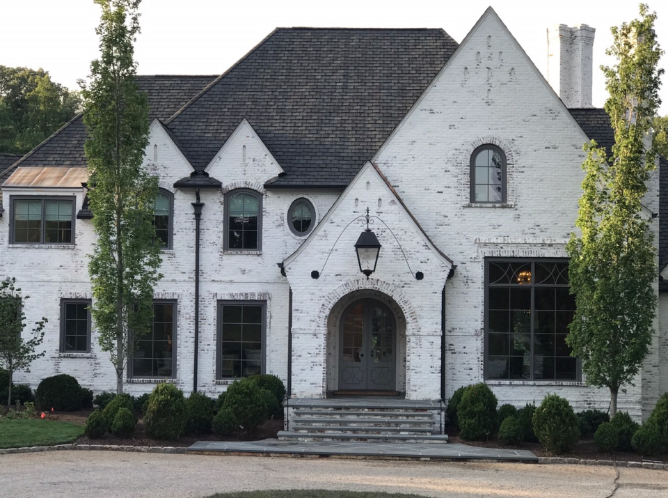 a white house with a large front door and a large front door