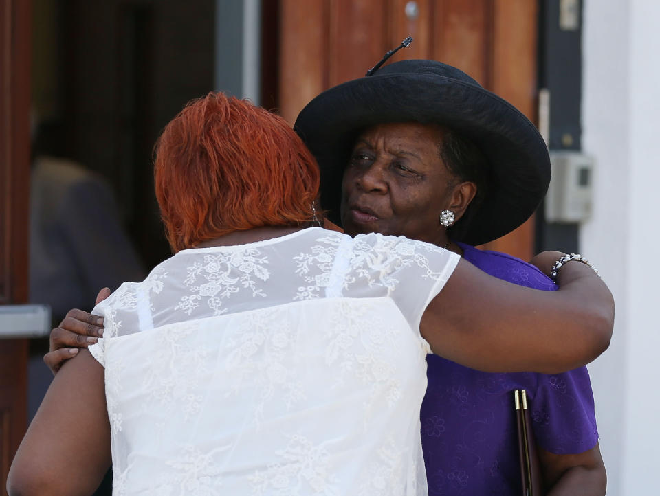 CHARLESTON, SC - JUNE 21:  People hug after leaving the Emanuel African Methodist Episcopal Church after attending the Sunday service, the first one held after a mass shooting at the church killed nine people on June 21, 2015 in Charleston, South Carolina. Dylann Roof, 21 years old, is suspected of killing the nine people during a prayer meeting in the church, which is one of the nation's oldest black churches in Charleston.  (Photo by Joe Raedle/Getty Images)