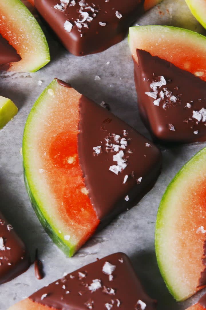 <p>By mixing coconut oil into melted chocolate, you're basically making a magic shell. It's not a totally necessary step, but it does help the chocolate harden — meaning the dipped watermelon is ready to eat pretty much immediately. </p><p>Get the <a href="https://www.delish.com/uk/cooking/recipes/a33631883/chocolate-covered-watermelon-recipe/" rel="nofollow noopener" target="_blank" data-ylk="slk:Chocolate Covered Watermelon;elm:context_link;itc:0;sec:content-canvas" class="link ">Chocolate Covered Watermelon</a> recipe.</p>