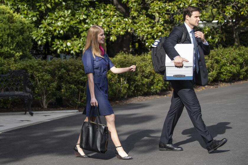 Special Assistant to the President and Oval Office Coordinator Molly Michael, left, and Director of the Presidential Personnel Office Johnny McEntee, walk to join President Donald Trump as he departs the White House, Friday, May 1, 2020, in Washington. Trump is en route to Camp David, Md.(AP Photo/Alex Brandon)