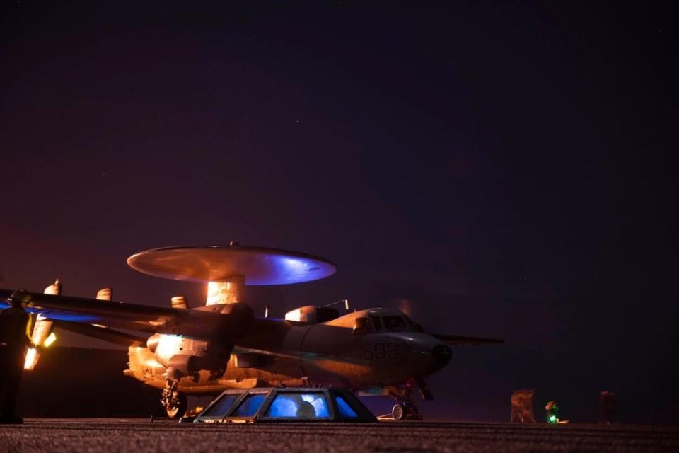 an aircraft on the flight deck of an aircraft carrier