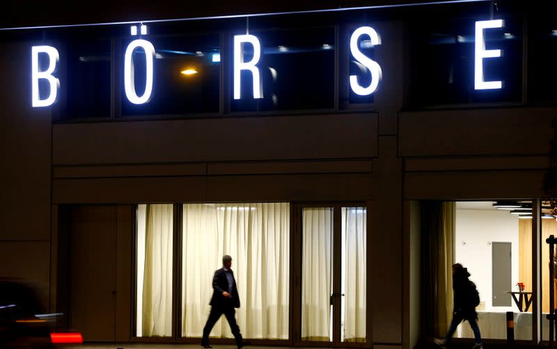 FILE PHOTO: A man walks under the illuminated word "Borse" as he passes the headquarters of Swiss stock exchange operator SIX Group in Zurich