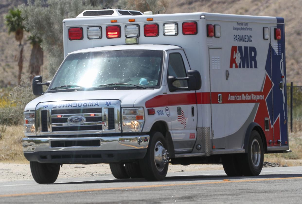 An ambulance responds to a crash scene.