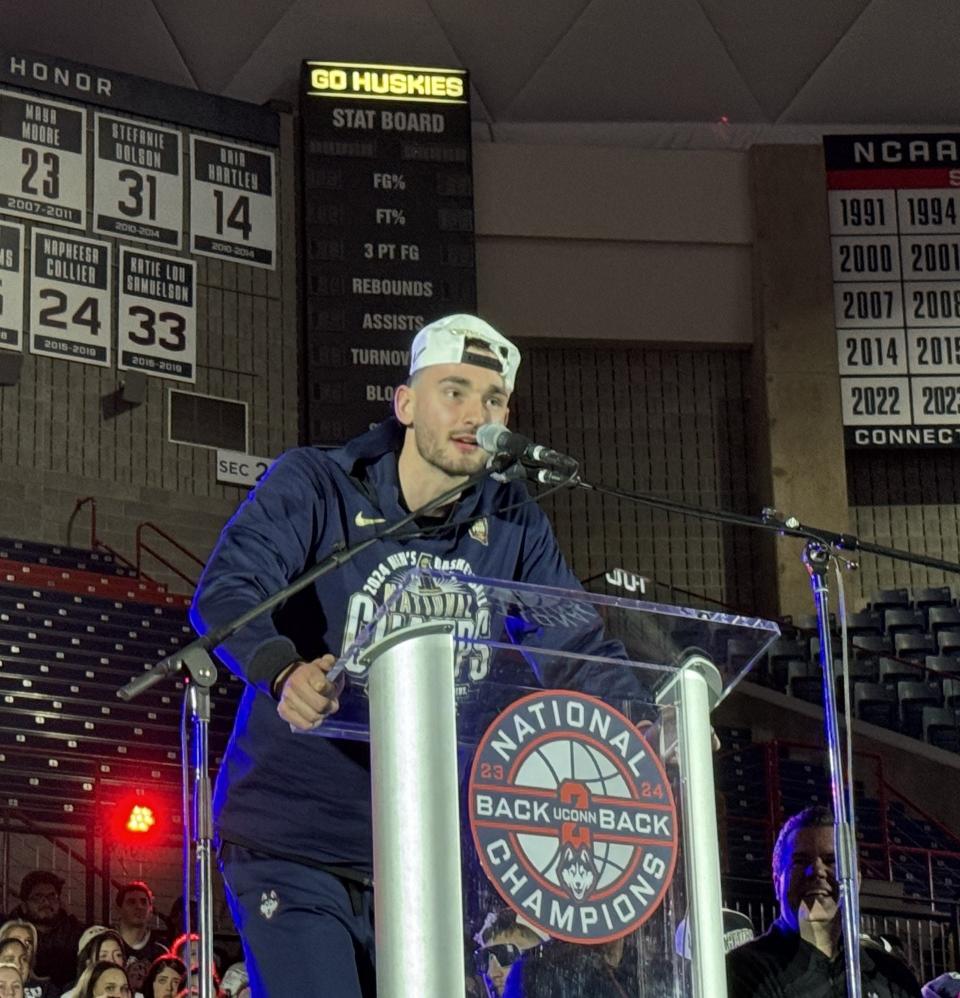 Alex Karaban, a redshirt sophomore forward on the UConn men's basketball team, speaks at the rally held for the team's national championship victory.
