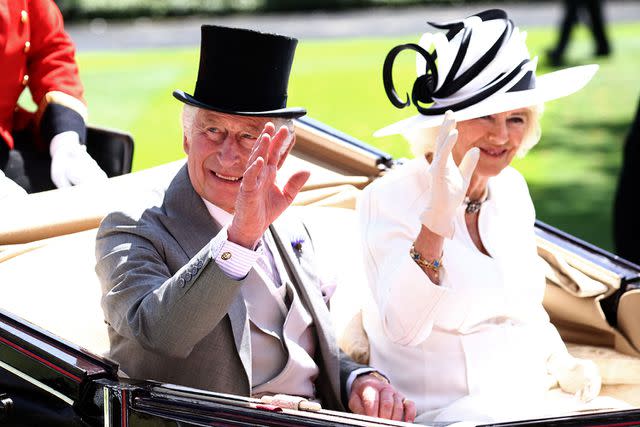 <p>HENRY NICHOLLS/AFP via Getty Images</p> King Charles and Queen Camilla arrive at Royal Ascot 2023