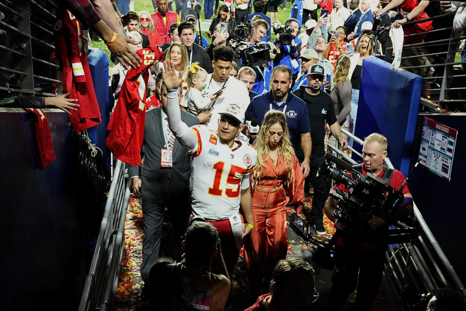 Kansas City Chiefs quarterback Patrick Mahomes (15) leaves the field with his wife, Brittany Mahomes, after the NFL Super Bowl 57 football game against the Philadelphia Eagles, Sunday, Feb. 12, 2023, in Glendale, Ariz. The Kansas City Chiefs defeated the Philadelphia Eagles 38-35. (AP Photo/David J. Phillip)