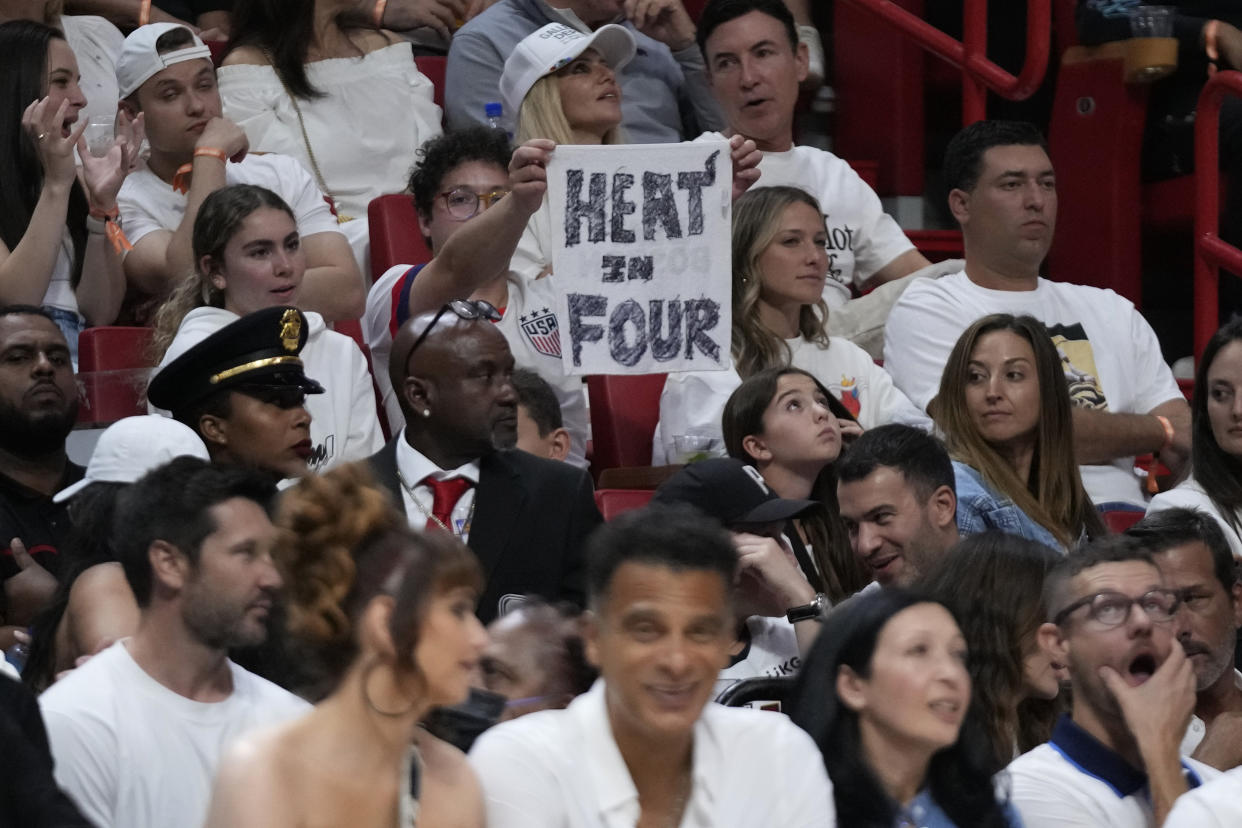 A fan hold up a sign during the second half during Game 3 of the NBA basketball playoffs Eastern Conference finals between the Miami Heat and the Boston Celtics, Sunday, May 21, 2023, in Miami. (AP Photo/Wilfredo Lee)