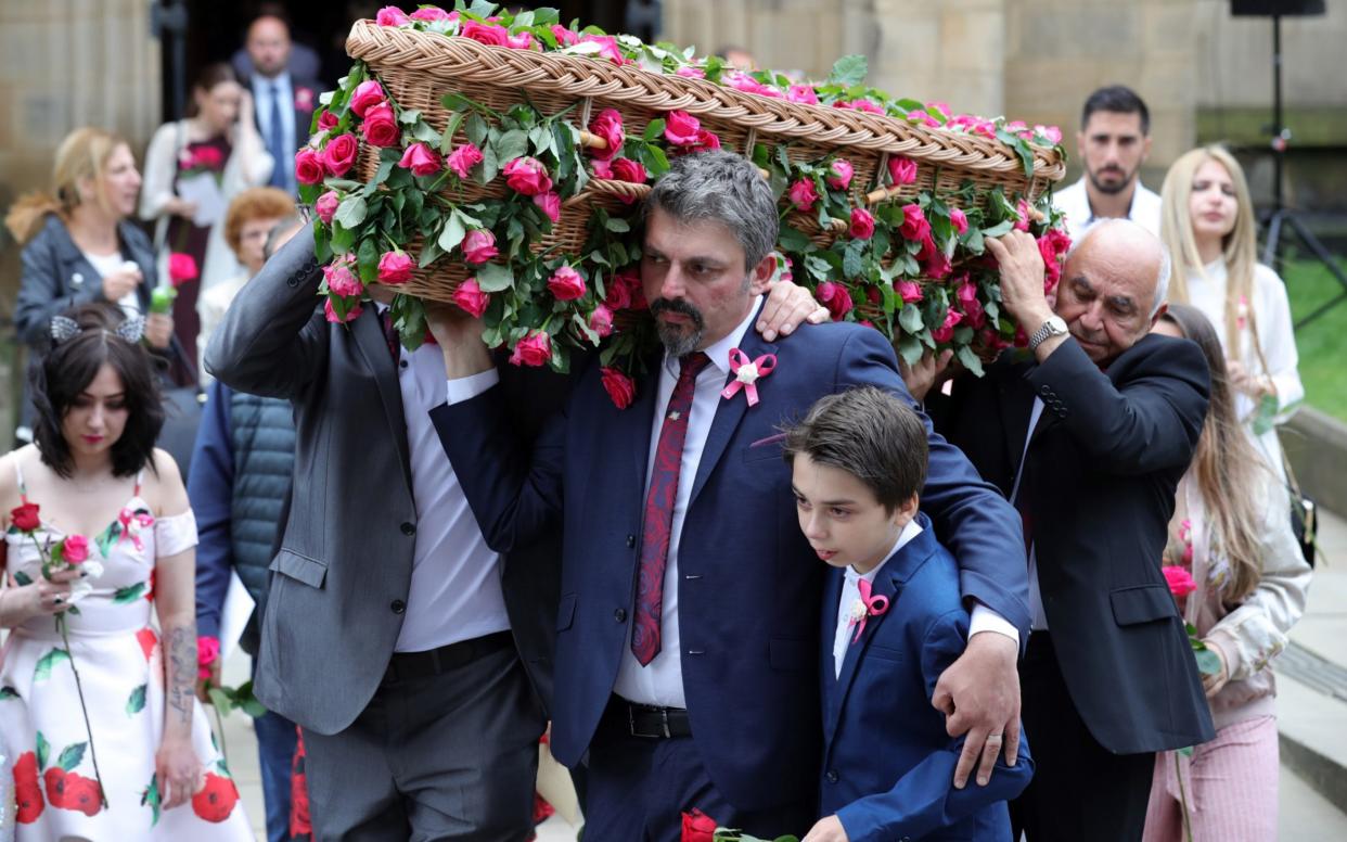 Andrew Roussos (centre), the father of Saffie, holds son Xander while carrying his daughter's coffin at Manchester Cathedral today - Getty Images Europe