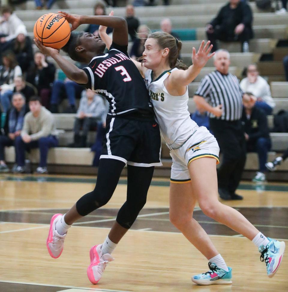 Ursuline's Jezelle Banks (left) drives against Saint Mark's Giana DiFebbo in the first half of Ursuline's 72-48 win at Saint Mark's, Thursday, Jan. 18, 2024.