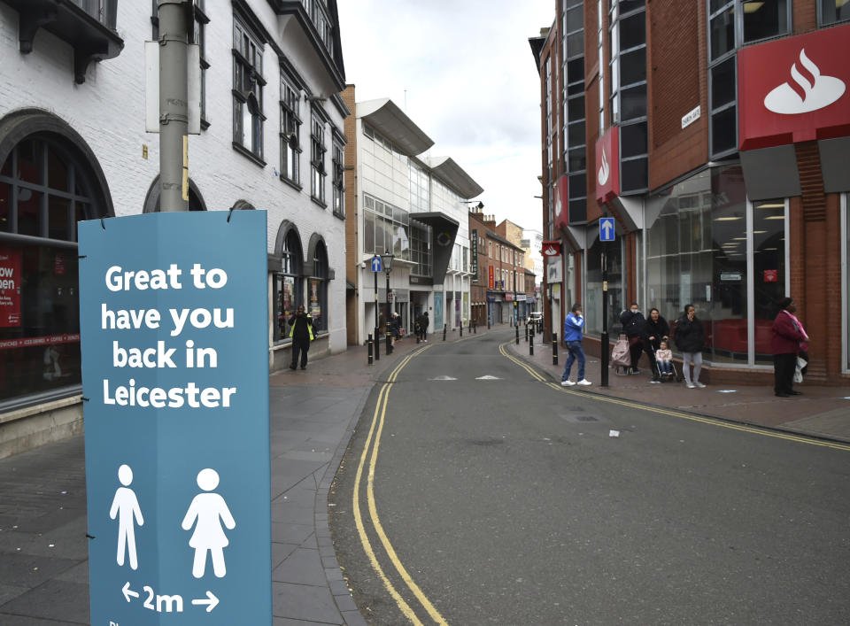People walk through Leicester city centre, England, Tuesday June 30, 2020. The British government has reimposed lockdown restrictions in the English city of Leicester after a spike in coronavirus infections, including the closure of shops that don't sell essential goods and schools. (AP Photo/Rui Vieira)