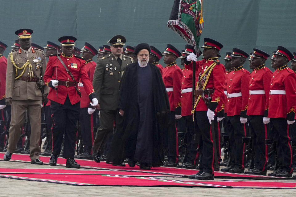 Iran's President Ebrahim Raisi, center, inspects the honor guard before meeting Kenya's President William Ruto at State House in Nairobi, Kenya Wednesday, July 12, 2023. Iran's president has begun a rare visit to Africa as the country, which is under heavy U.S. economic sanctions, seeks to deepen partnerships around the world. (AP Photo/Khalil Senosi)