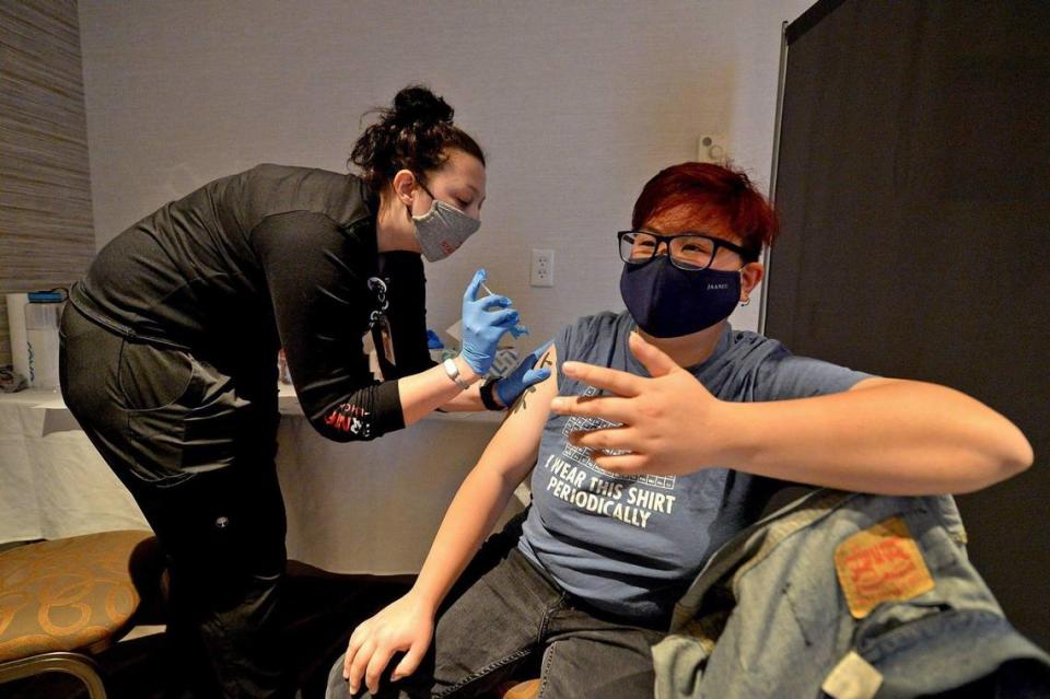 Madeline Seebold, a student nurse, administers a Pfizer-BioNTech COVID-19 vaccination shot to Raphael Law, at the Sheraton Charlotte Airport Hotel on Wednesday, April 14, 2021. StarMed’s walk-in vaccine clinic was part of a growing number of walk-in opportunities to get the vaccine in the Charlotte area.