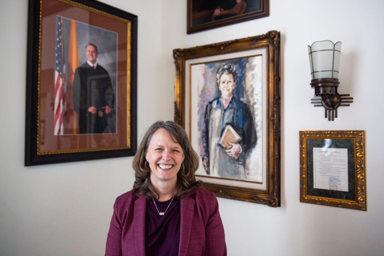 New Mexico Supreme Court Chief Justice C. Shannon Bacon poses for a photo next to the portrait of Justice Mary Walters, the first female New Mexico Supreme Court justice, on Friday, Jan. 12, 2024, at the New Mexico Supreme Court in Sante Fe.