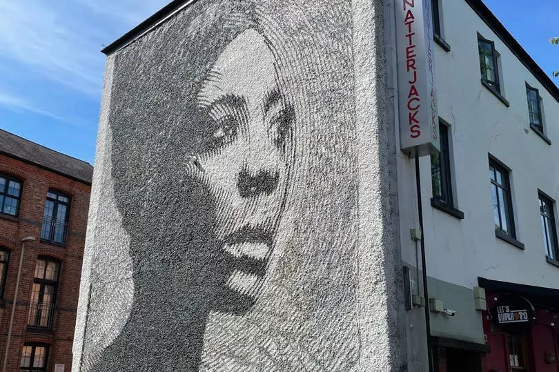 A street mural of a woman in Leicester