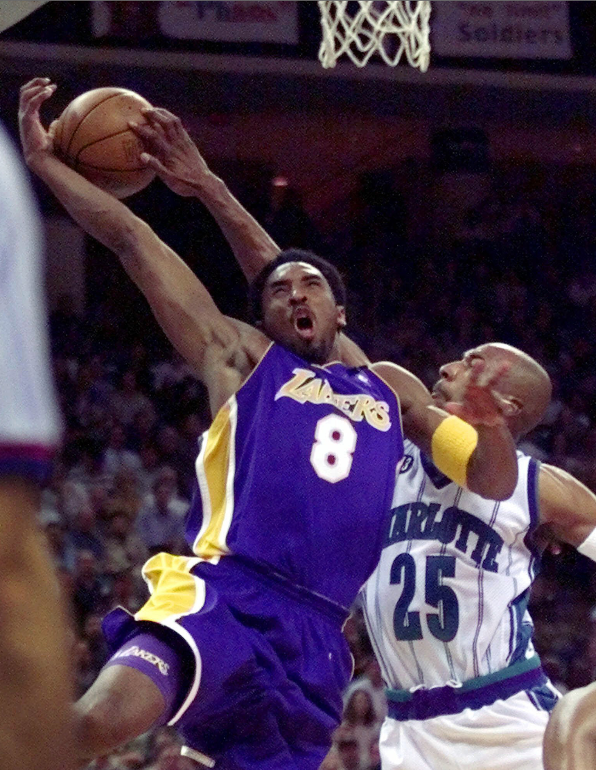 Former North Brunswick High School basketball player Chucky Brown (25) defends against Kobe Bryant during Brown's time with the NBA Charlotte Hornets.