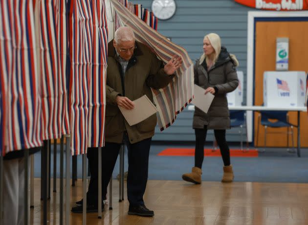 Voters cast their ballots at a polling location setup at Winnacunnet High School on Jan. 23 in Hampton, New Hampshire.