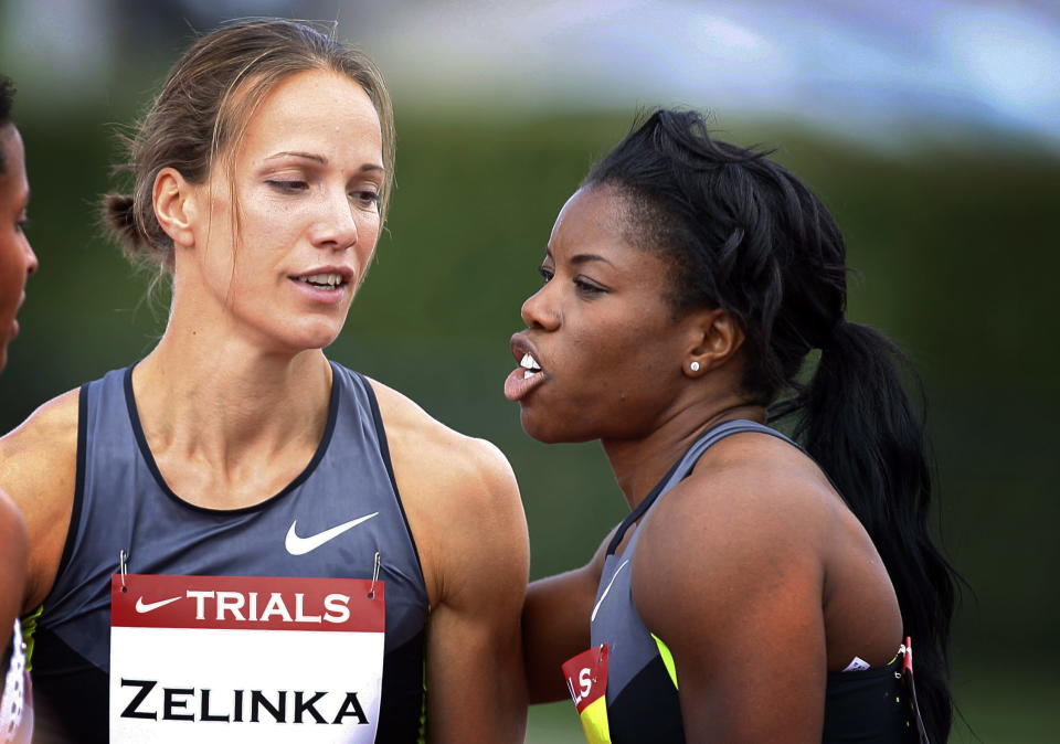 Jessica Zelinka, left, from London, Ont., is congratulated by Perdita Felicien, from Pickering, after Zelinka won the women's 100-metre hurdles at the Canadian Track and Field Championships in Calgary, Alta., Saturday, June 30, 2012.THE CANADIAN PRESS/Jeff McIntosh