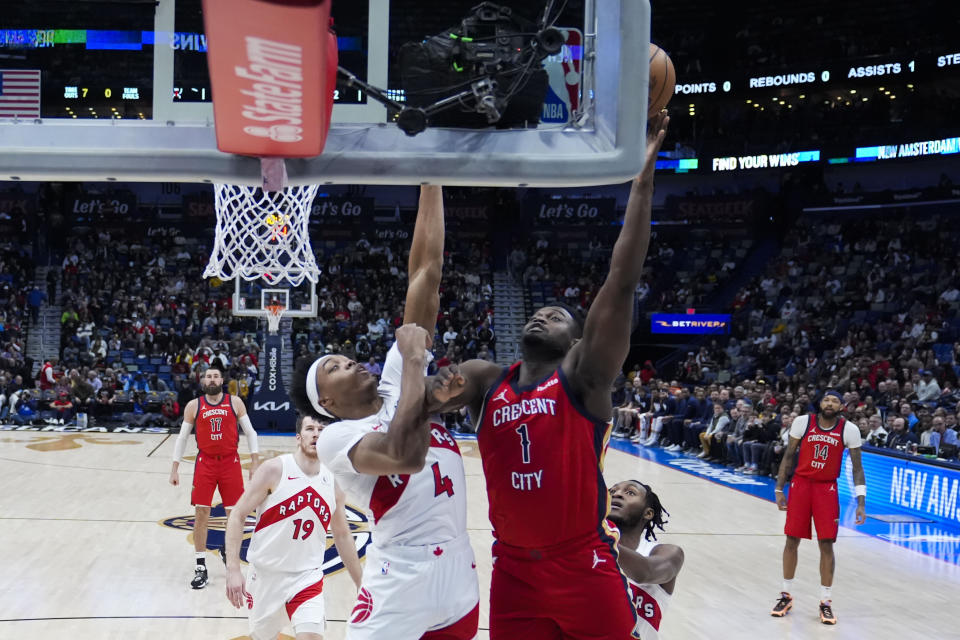 New Orleans Pelicans forward Zion Williamson (1) goes to the basket against Toronto Raptors forward Scottie Barnes (4) in the first half of an NBA basketball game in New Orleans, Monday, Feb. 5, 2024. (AP Photo/Gerald Herbert)