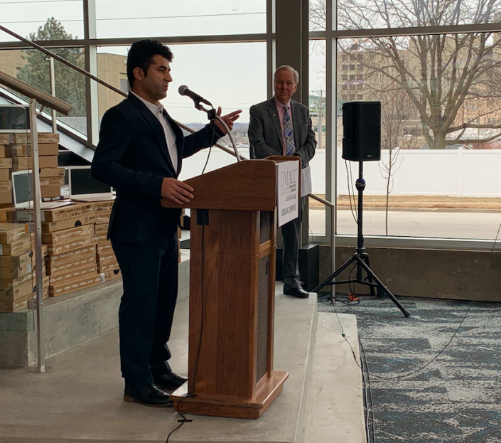 Nabi Mohammadi speaks at a news conference Thursday about Des Moines Area Community College&#39;s donation of laptops to Afghan refugees resettling in the Des Moines area. DMACC President Rob Denson made the announcement.