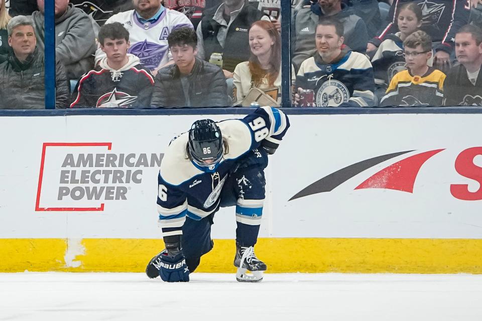 Blue Jackets left wing Kirill Marchenko struggles to get to his feet after taking a hit during the second period of Columbus' 5-3 loss to the Penguins.