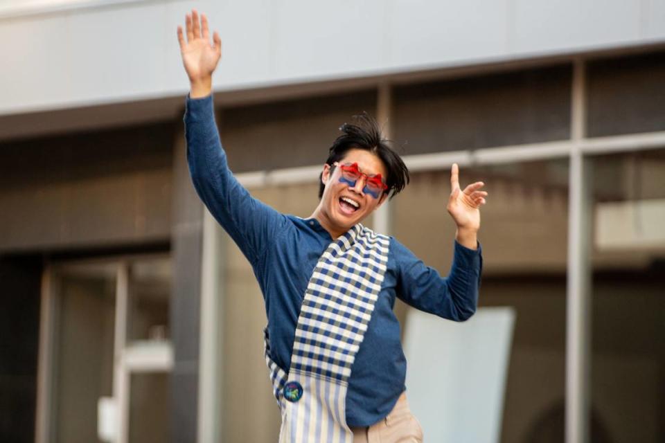 A participant in the Star Lumber Sundown Parade calls to the crowd on Market. The parade was one of several events to help kick off the start of the nine-day Riverfest.