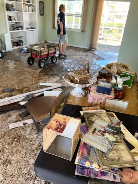 PHOTO: Photos are piled in an area of a Fort Myers, Florida, home damaged during Hurricane Ian. (Courtesy of Impressions Photography)
