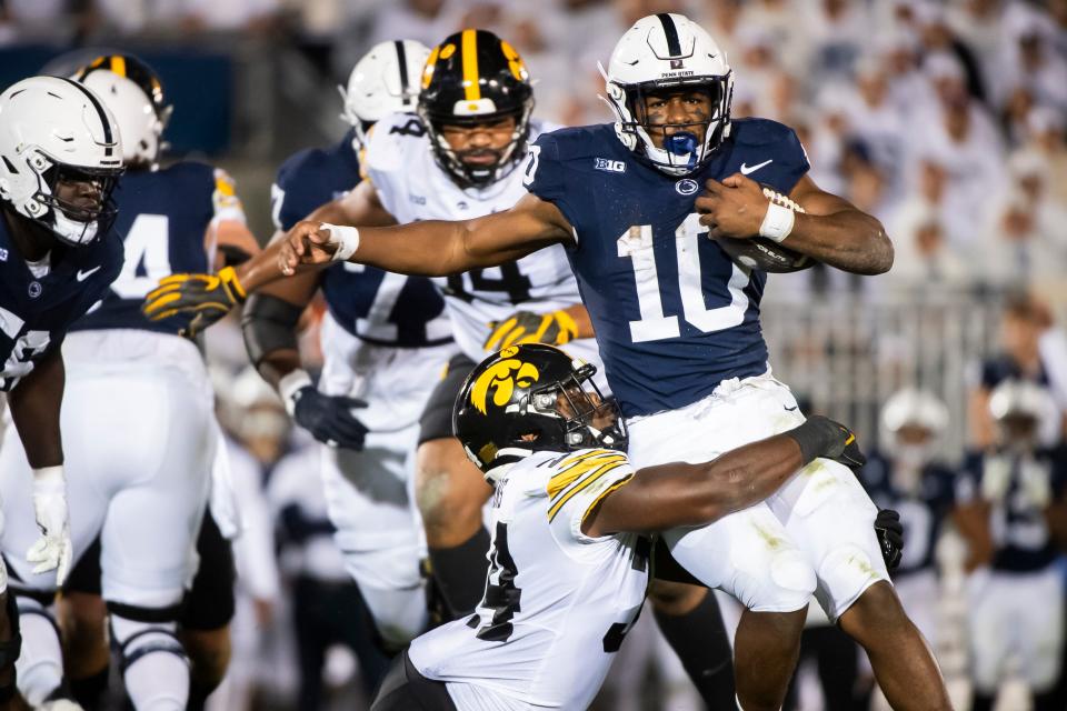 Iowa linebacker Jay Higgins tackles Penn State running back Nick Singleton near the line of scrimmage during the White Out game at Beaver Stadium Saturday, Sept. 23, 2023, in State College, Pa.