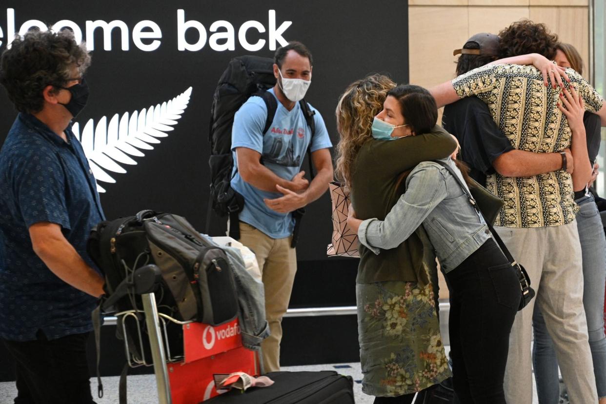 Family members embrace each other at Sydney International Airport