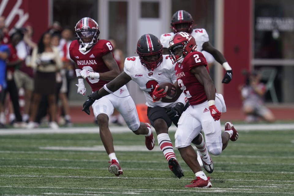 Indiana running back Shaun Shivers (2) is chased by Western Kentucky linebacker JaQues Evans (3) during the second half of an NCAA college football game, Saturday, Sept. 17, 2022, in Bloomington, Ind. Indiana won 33-30 in overtime. (AP Photo/Darron Cummings)