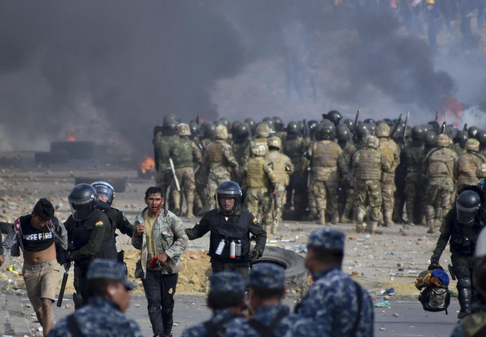 Police detain supporters of former President Evo Morales during clashes in Sacaba, Bolivia, Nov. 15, 2019. (AP Photo/Dico Solis)