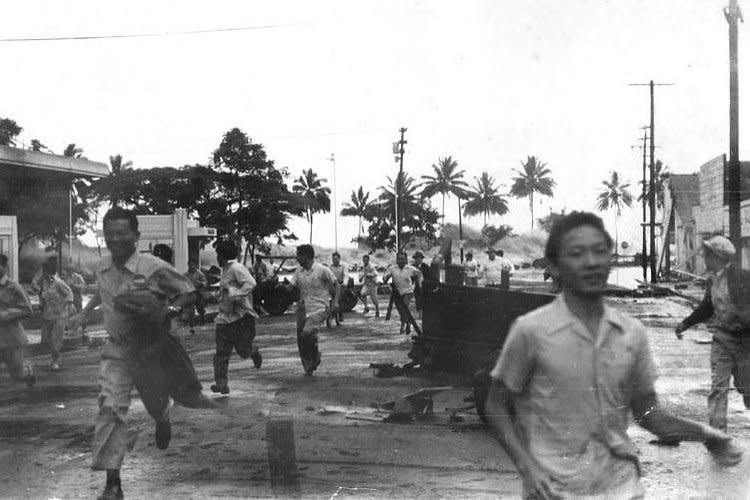 People run away from an approaching tsunami in Hilo, Hawaii, on April 1, 1946. The tsunami was sparked by an earthquake in the Aleutian Islands about 4 hours earlier. File Photo courtesy of the Pacific Tsunami Museum/Wikimedia