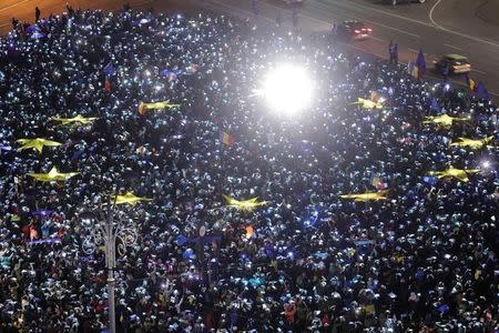 Romanians light up blue pieces of paper and pieces of yellow star shaped fabric thus forming the European Union flag during a protest against the government, in Bucharest, Romania, February 26, 2017. Inquam Photos/Octav Ganea/via REUTERS