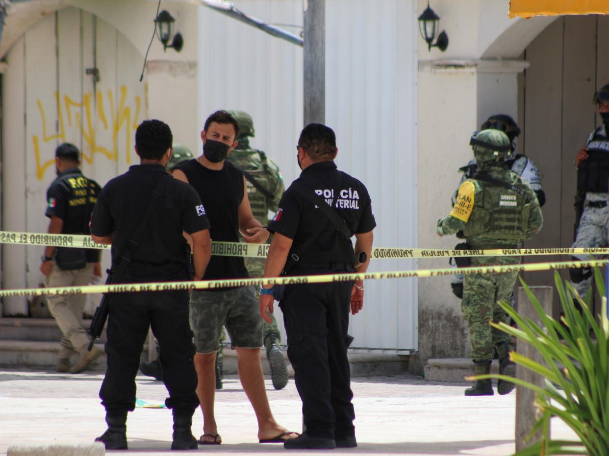 Police officers and soldiers are pictured during an operation one day after the murder of two men and where a tourist was injured during the shooting at Tortugas beach in Cancun, Mexico June 12, 2021.  (REUTERS)