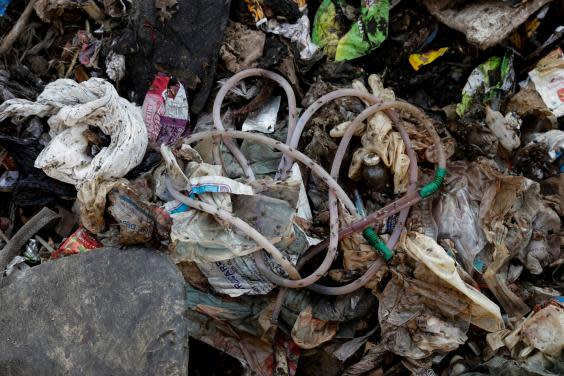 Disposed medical waste lies on the floor of a landfill site (Reuters)