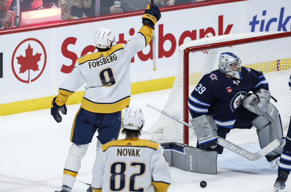 Nashville Predators' Filip Forsberg (9) celebrates after his goal against Winnipeg Jets goaltender Laurent Brossoit (39) during second-period NHL hockey game action in Winnipeg, Manitoba, Thursday, Nov. 9, 2023. (John Woods/The Canadian Press via AP)