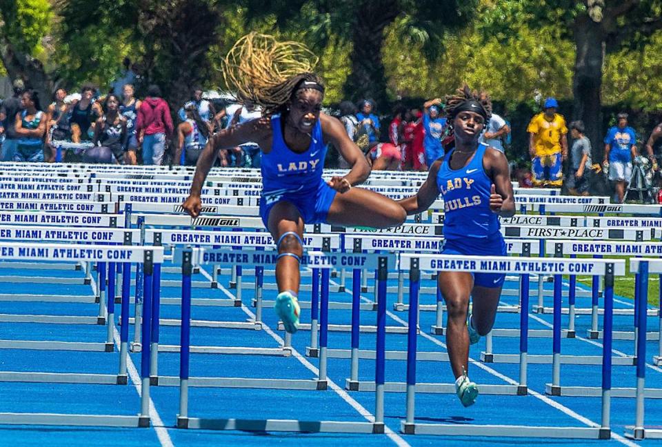 Athlete Sariyah Morales (left), Junior at Miami Northwestern, wins the section 1 of 4 Finals of the Girls 100 Meters Hurdles at the GMAC track and field completion at the Traz Powell Stadium in Miami, on Saturday April 15, 2023.