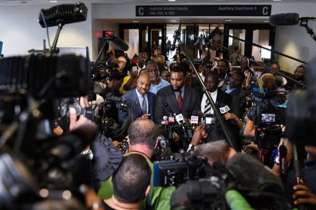 Botham Jean's family attorneys, Daryl Washington, Lee Merrit & Benjamin Crump address the press after the conviction charge of murder was delivered after deliberations in the trial of former Dallas police officer Amber Guyger in Dallas
