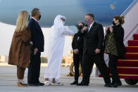 Secretary of State Mike Pompeo, second from right, elbow-bumps Shihab al-Faheem, chief of protocol with the United Arab Emirates' Ministry of Foreign Affairs, as he and his wife Susan, right, step off a plane at Al Bateen Executive Airport in Abu Dhabi, United Arab Emirates, Friday, Nov. 20, 2020. Also pictured are Terry Rakolta, left, and her husband, U.S. Ambassador to the UAE John Rakolta. (AP Photo/Patrick Semansky, Pool)