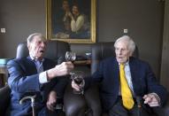 The world's oldest living twin brothers, Paulus (L) and Pieter Langerock from Belgium, 102, toast while sitting in their living room at the Ter Venne care home in Sint-Martens-Latem, Belgium, August 11, 2015. REUTERS/Yves Herman