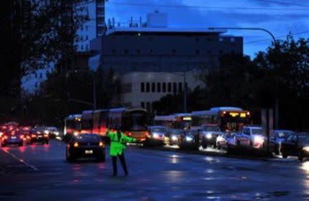 Police direct traffic in the central business district (CBD) of Adelaide after severe storms and thousands of lightning strikes knocked out power to the entire state of South Australia, September 28, 2016. AAP/David Mariuz/via REUTERS