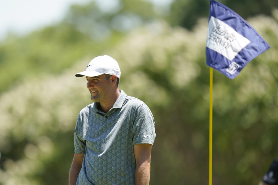 Scottie Scheffler smiles before putting on the fifth hole during a windy day of the final round of the Charles Schwab Challenge golf tournament at the Colonial Country Club in Fort Worth, Texas, Sunday, May 29, 2022. (AP Photo/LM Otero)