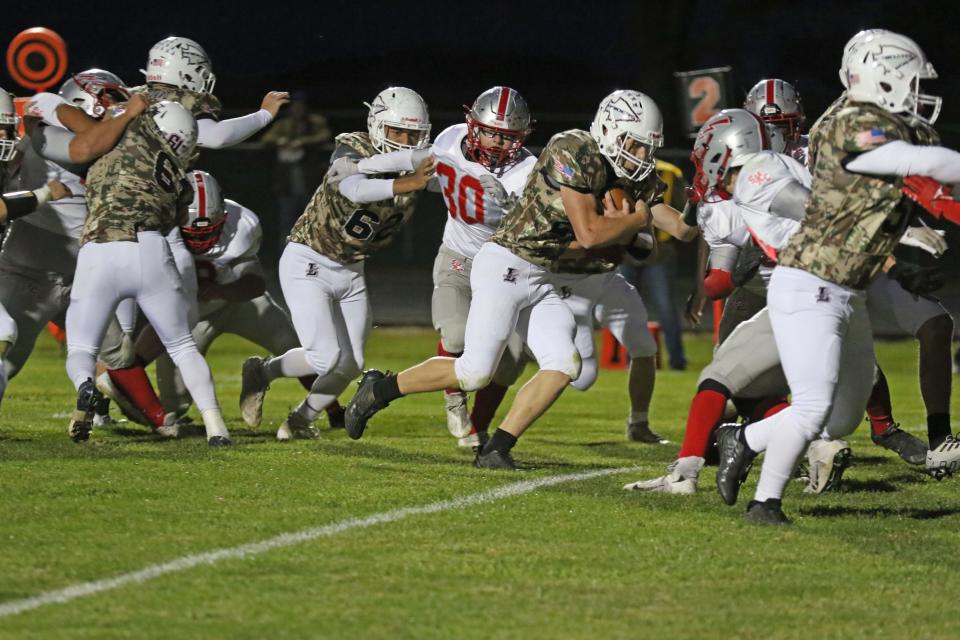 Lakota's Micah Williams carries the ball.