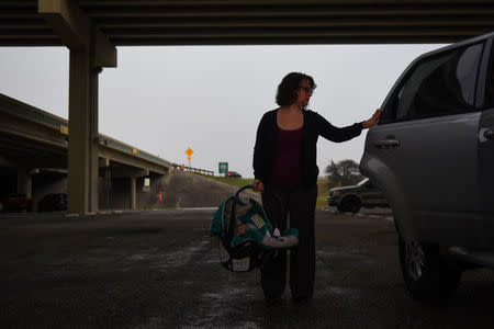 Lauren Hoffman drops off her sons with her father-in-law before going to work in San Antonio, Texas, U.S., February 26, 2019. REUTERS/Callaghan O'Hare